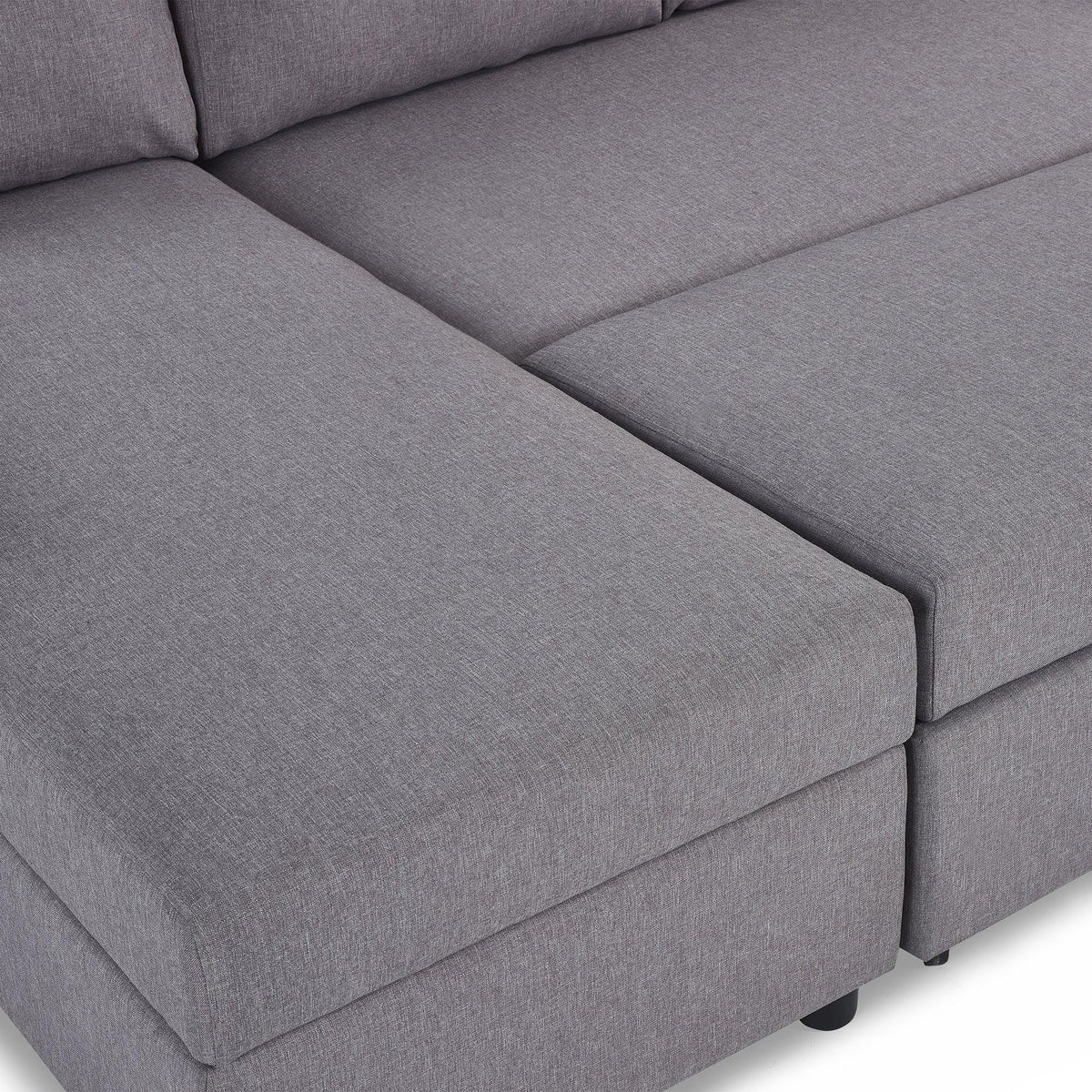 Close-up of grey fabric sofabed with storage feature and cushioned seating