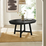 Extended black round wooden dining table with books and vase on top in bright room