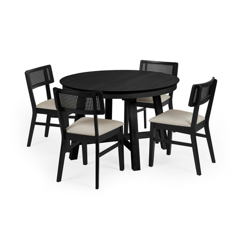 Round black wood dining table with four black chairs featuring woven cane backrests and beige cushions