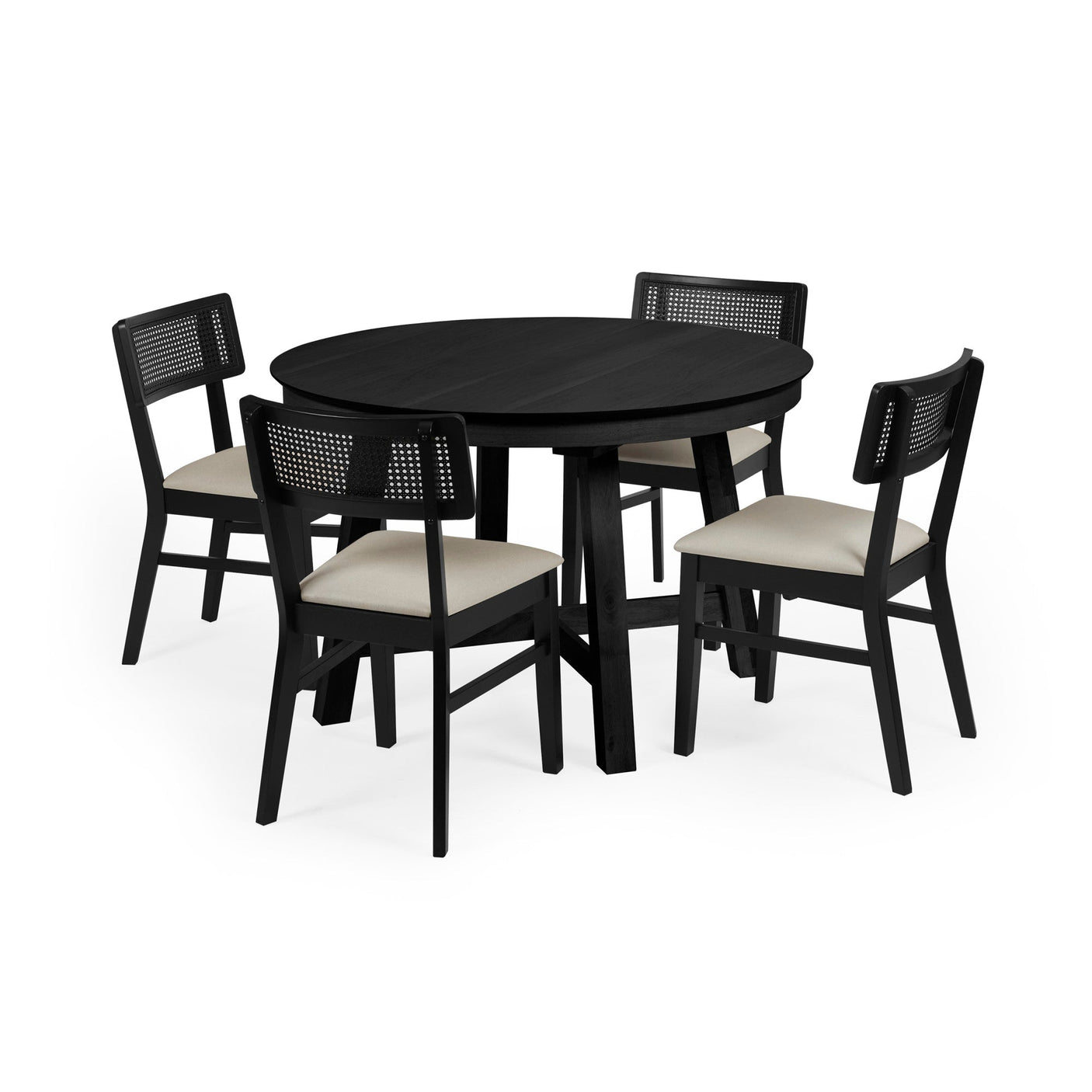 Set of four black wooden dining chairs with rattan backs and cream fabric seats around round black wooden table.