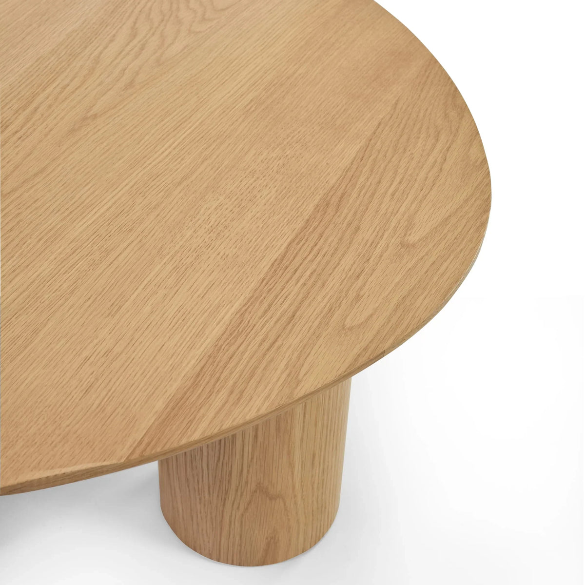 Round oak coffee table top with cylindrical wooden leg close-up