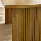 Oak dining table with slatted wooden base and rectangular top on textured beige rug