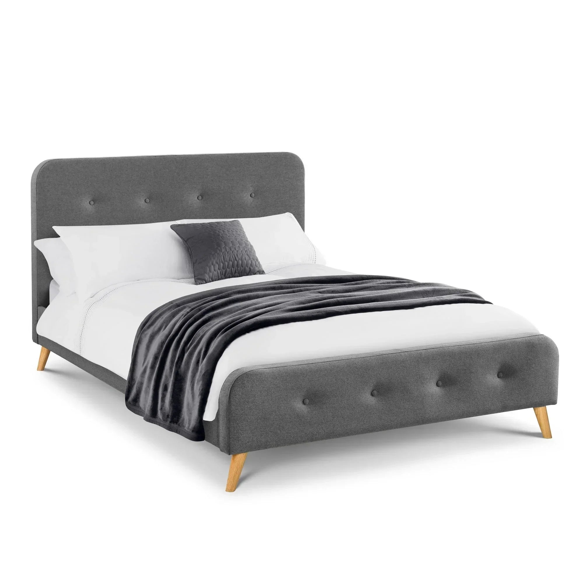 Grey linen double bed with cushioned headboard, wood legs, and bedding in studio setting