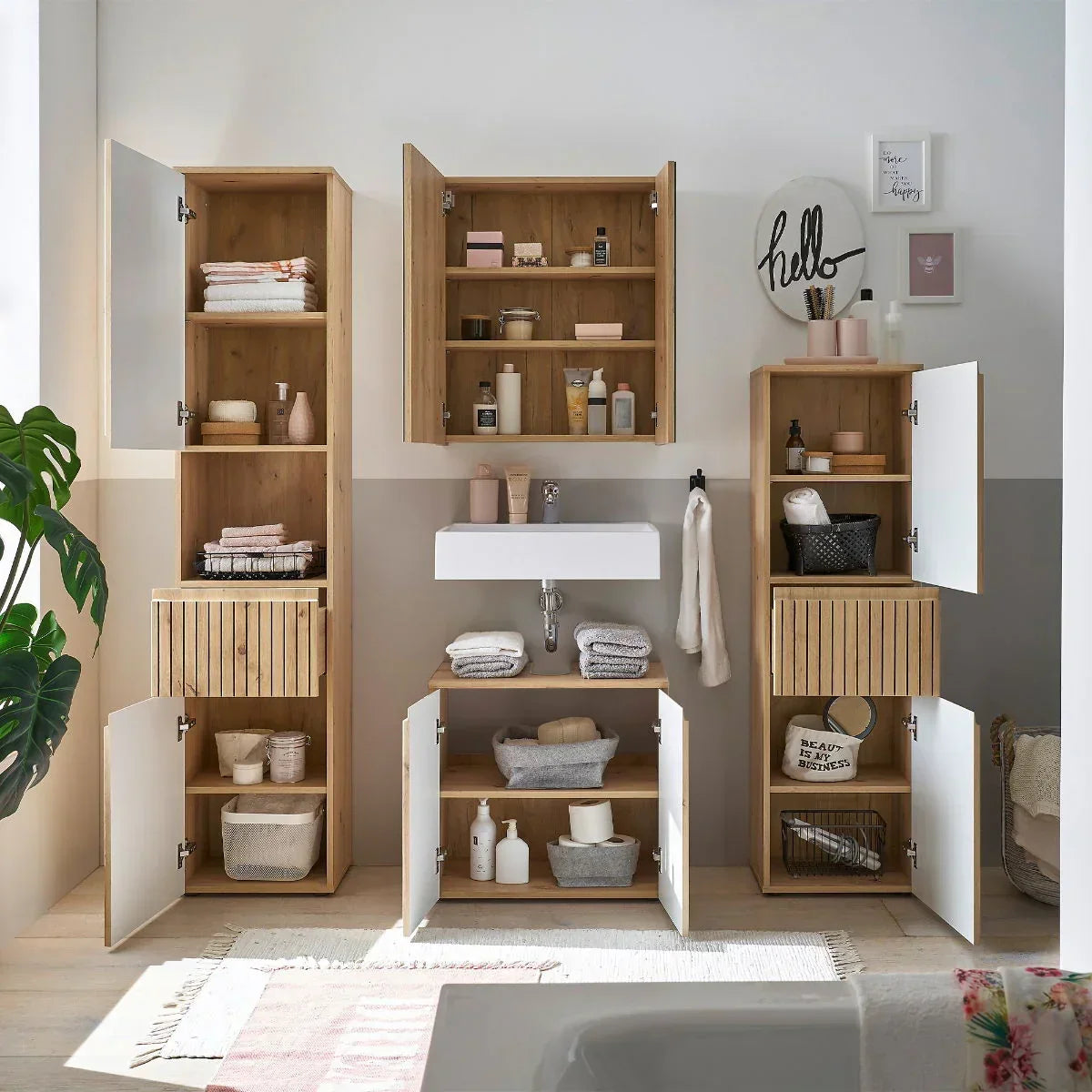 Oak bathroom furniture set with open storage cabinets, shelving, and white sink unit
