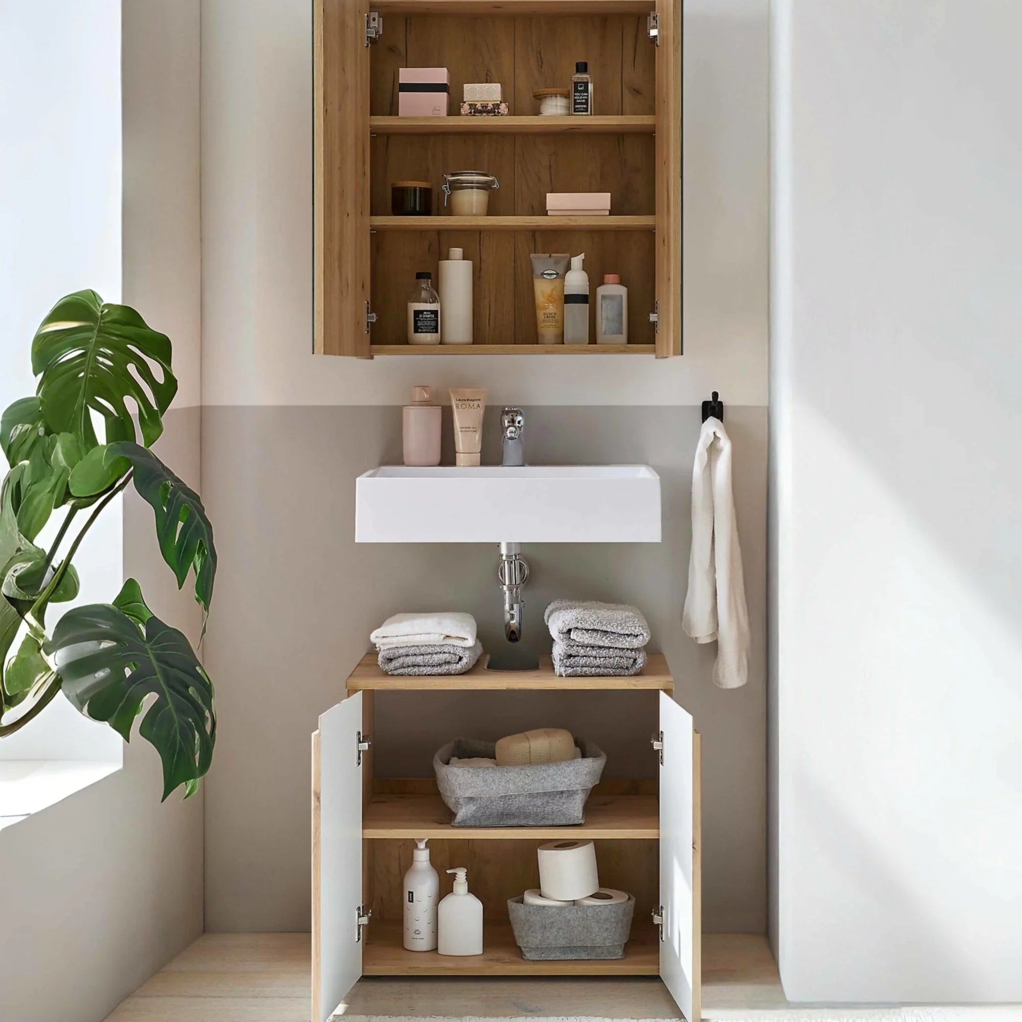 Oak bathroom vanity unit with open storage shelves, white basin and matching wall cabinet