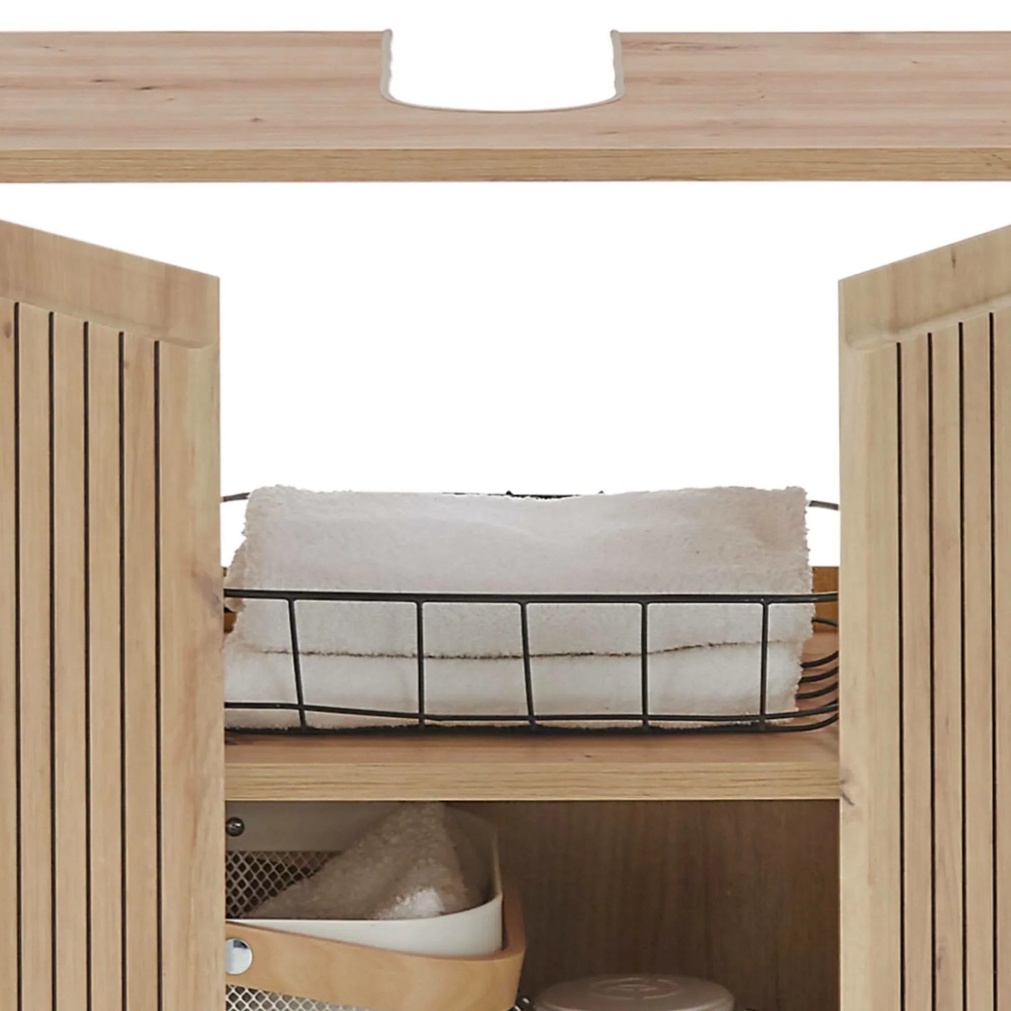 Oak bathroom cabinet with slatted doors, towel basket and storage shelf interior view