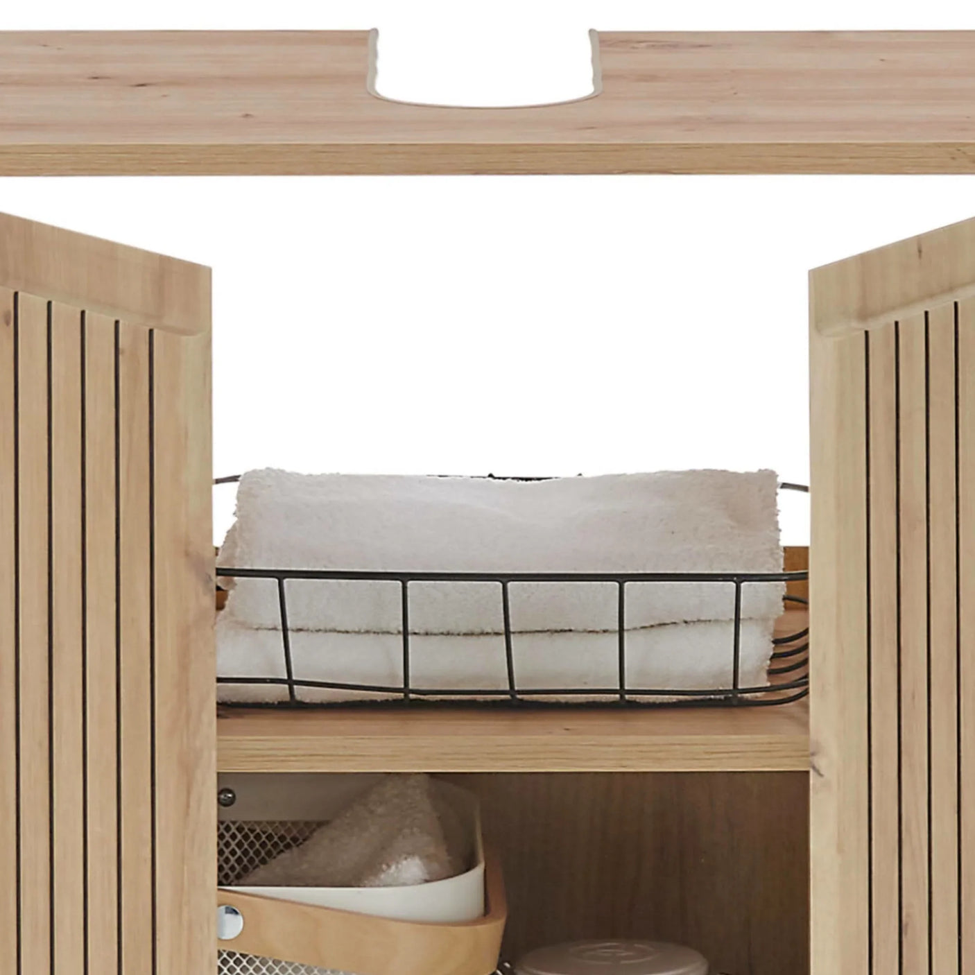 Oak bathroom cabinet with slatted doors, towel basket and storage shelf interior view