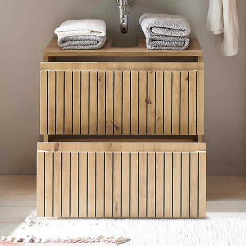 Wooden bathroom vanity unit with two drawers and stacked folded towels on top