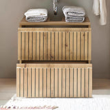 Wooden bathroom vanity unit with two drawers and stacked folded towels on top
