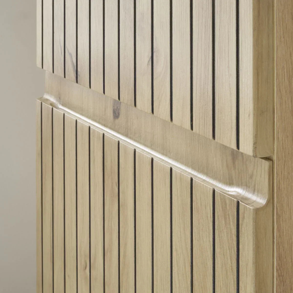 Light oak highboard door detail with vertical grooves and integrated wooden handle