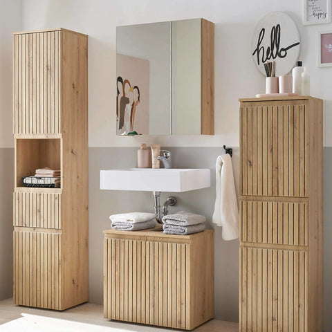 Oak bathroom furniture set with cabinets, mirror unit, and sink in modern bathroom