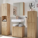 Oak bathroom furniture set with cabinets, mirror unit, and sink in modern bathroom