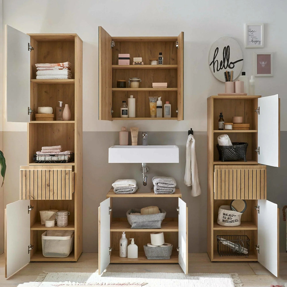 Oak bathroom storage cabinets with open doors and shelves beside white sink