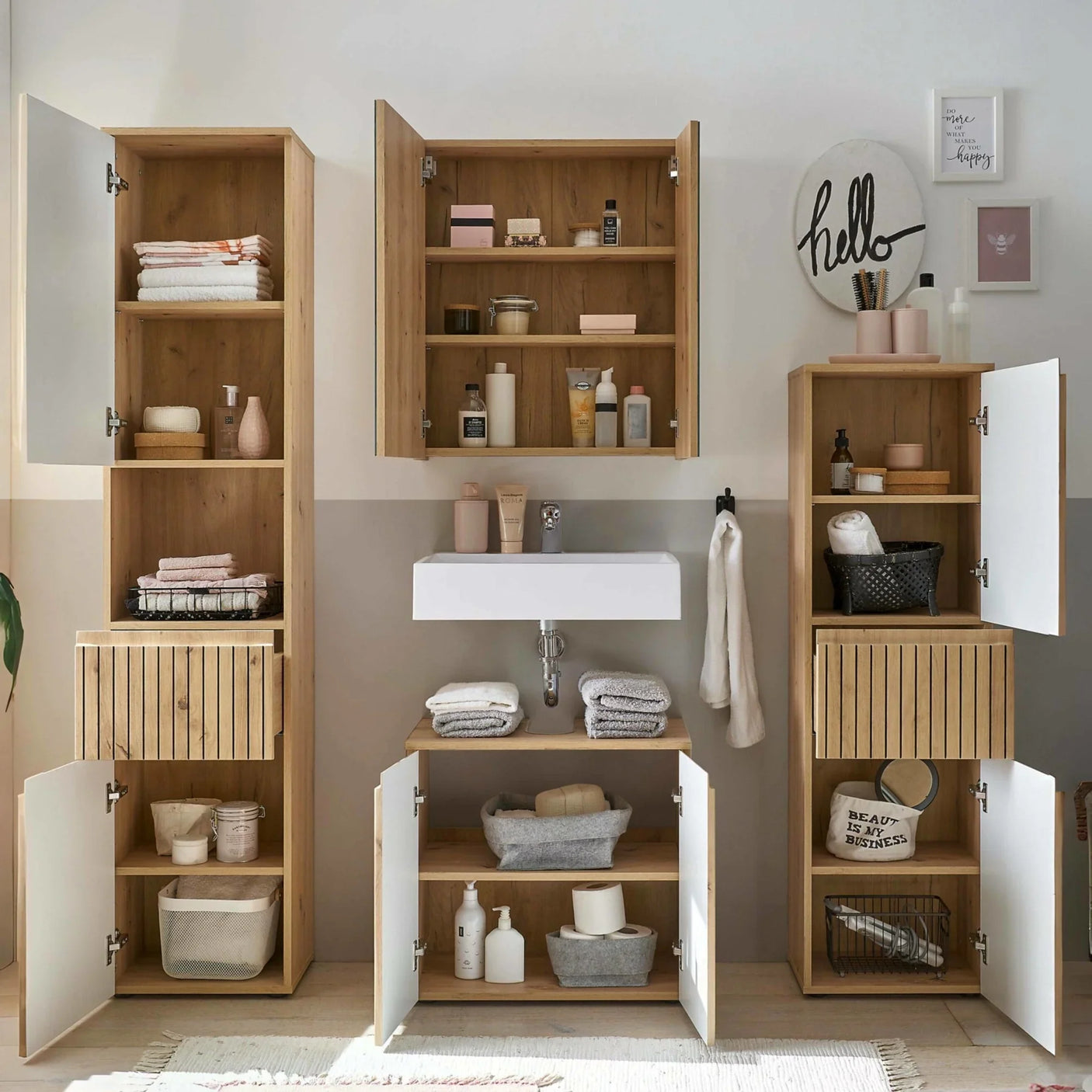 Oak bathroom storage cabinets with open doors and shelves beside white sink