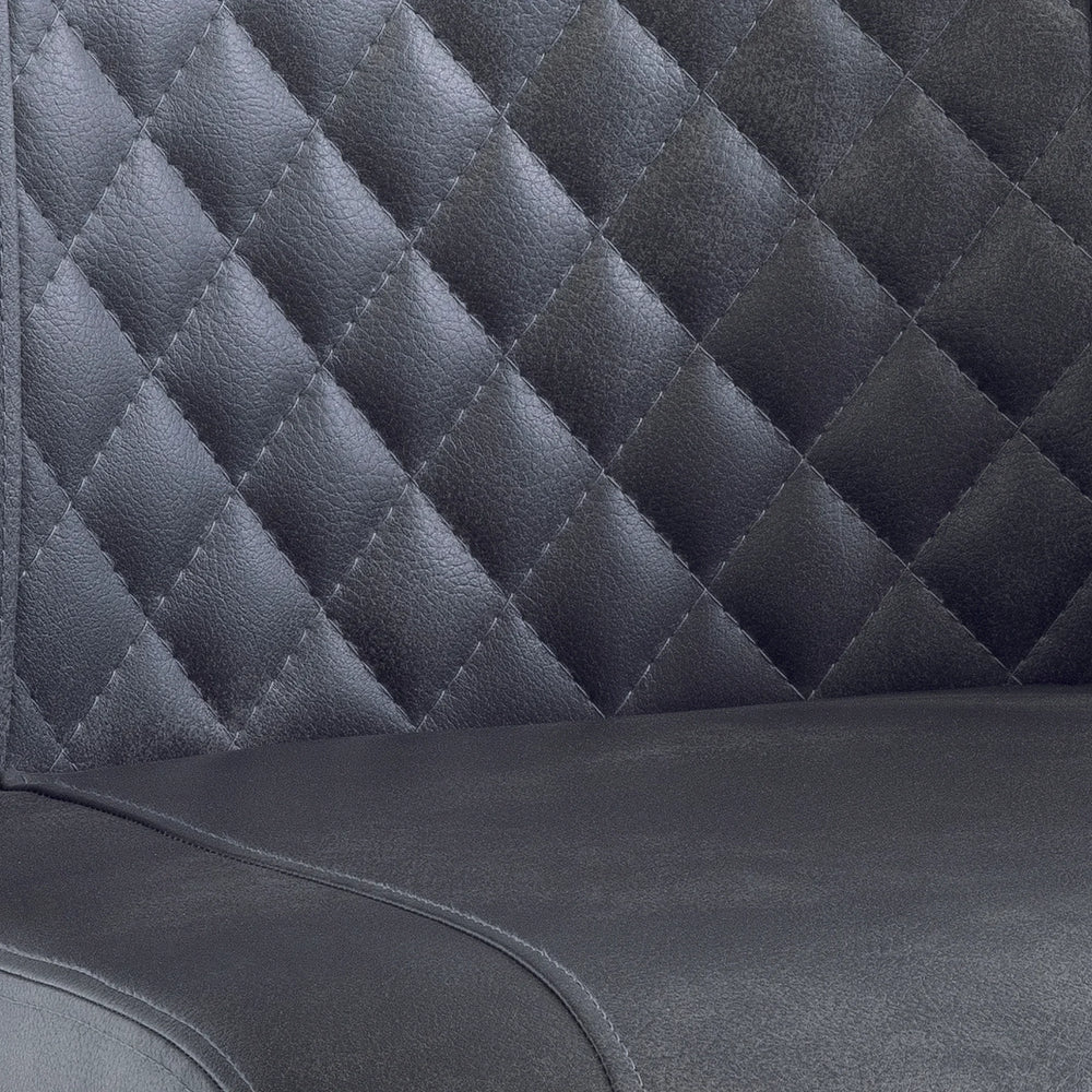Close up of black faux leather dining chair with quilted diamond stitched backrest