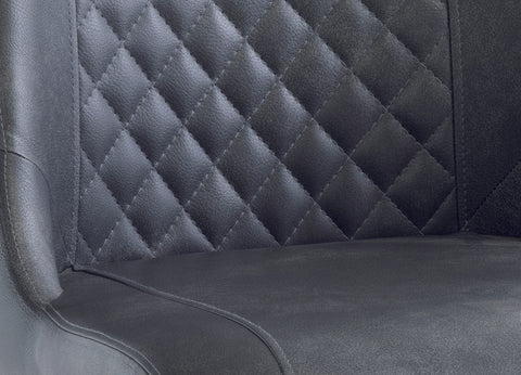 Close up of black faux leather dining chair with quilted diamond stitched backrest