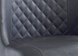 Close up of black faux leather dining chair with quilted diamond stitched backrest