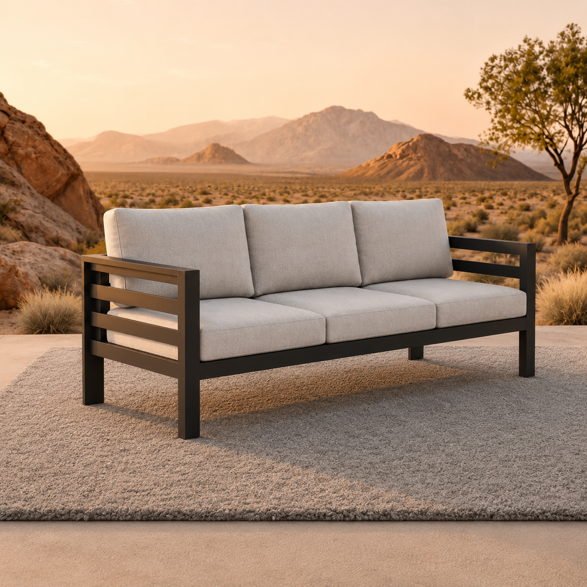 Light grey fabric cushions on a black metal frame sofa placed on a textured rug outdoors.