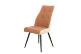 Salmon fabric dining chair with black metal legs and cream side panels, angled front view