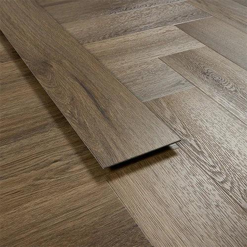 Antique walnut laminate flooring plank with wood grain detail in herringbone pattern