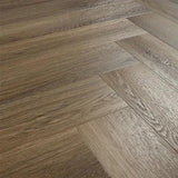 Antique walnut wood flooring in herringbone pattern with natural grain texture