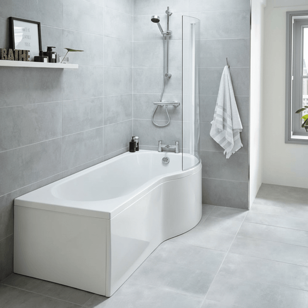 Modern bathroom with a white bathtub against a gray tiled wall.