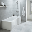Modern bathroom with a white bathtub against a gray tiled wall.