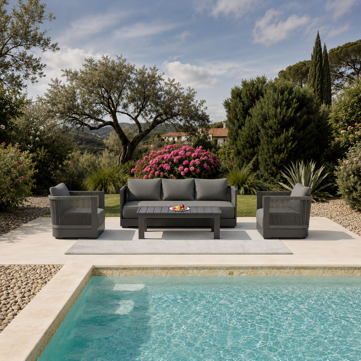 Dark grey cushioned outdoor sofa set with armchairs and table by a poolside | Home Centre Direct UK