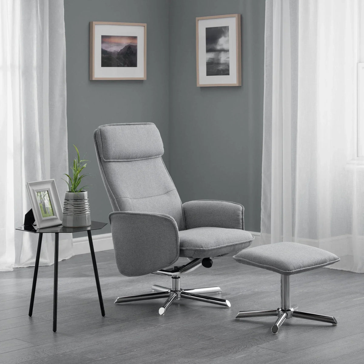 Grey recliner chair with matching footstool and chrome base in modern living room