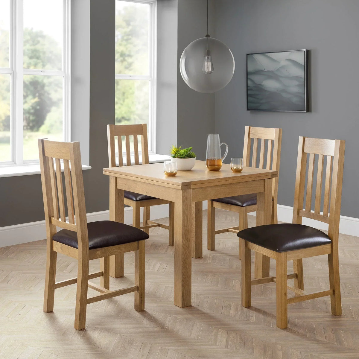 Oak dining table with four matching slat-back chairs in modern dining room
