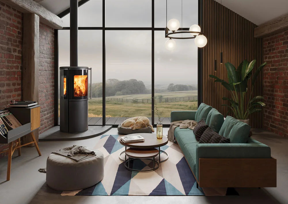 Modern living room featuring an Atlas wood burning stove, with a cozy seating area and large windows overlooking a scenic