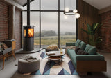 Modern living room featuring an Atlas wood burning stove, with a cozy seating area and large windows overlooking a scenic