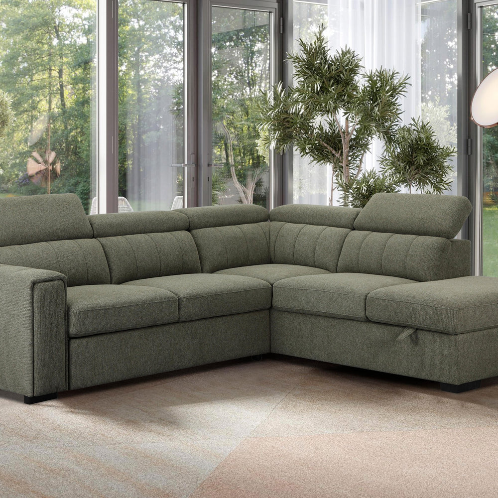 Green sectional sofa in a living room with large windows and plants.