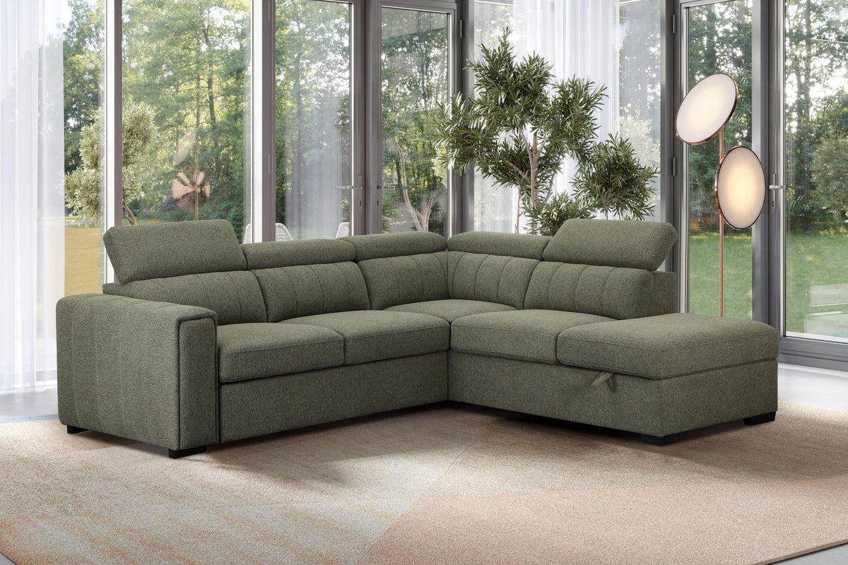 Green sectional sofa in a living room with large windows and plants.