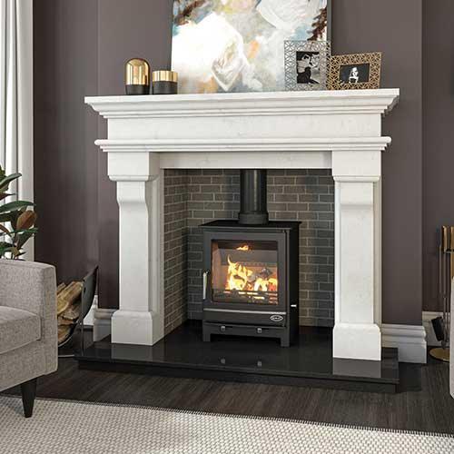 marble fireplace with inset wood burning stove against brick interior, modern living room decor