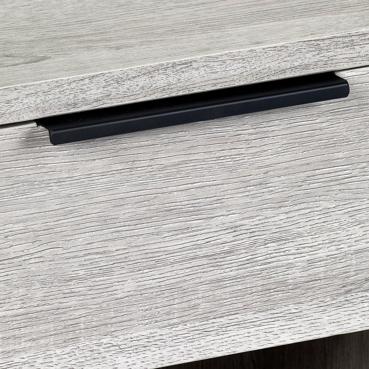 Grey oak bedside table drawer with black metal handle closeup
