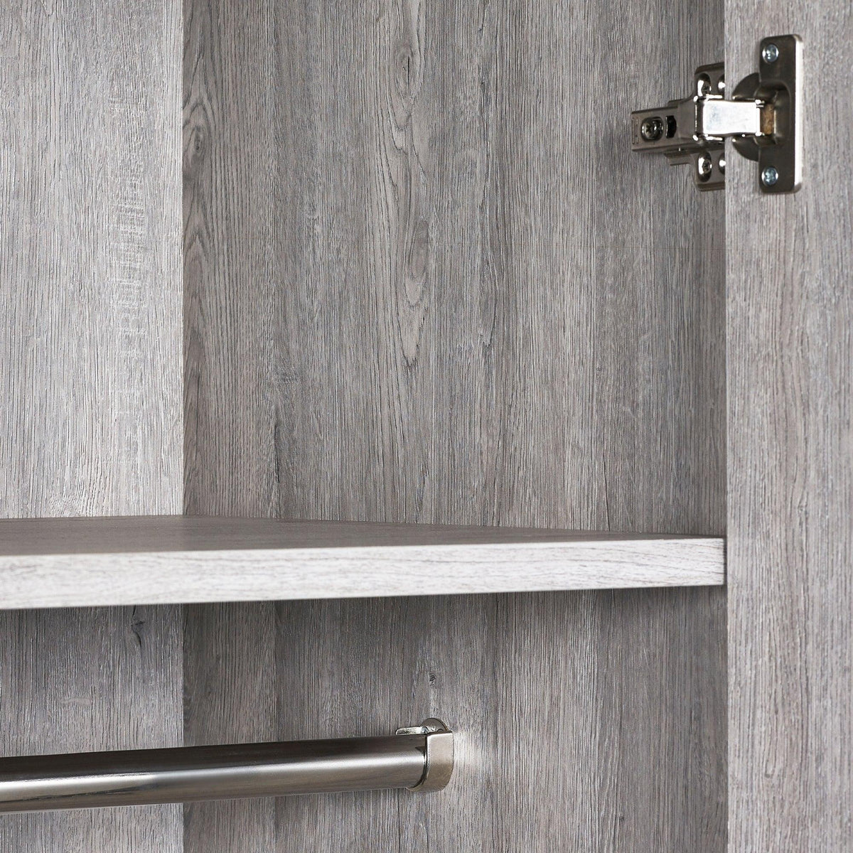 Grey wood wardrobe interior with shelf, metal hanging rail and door hinge detail
