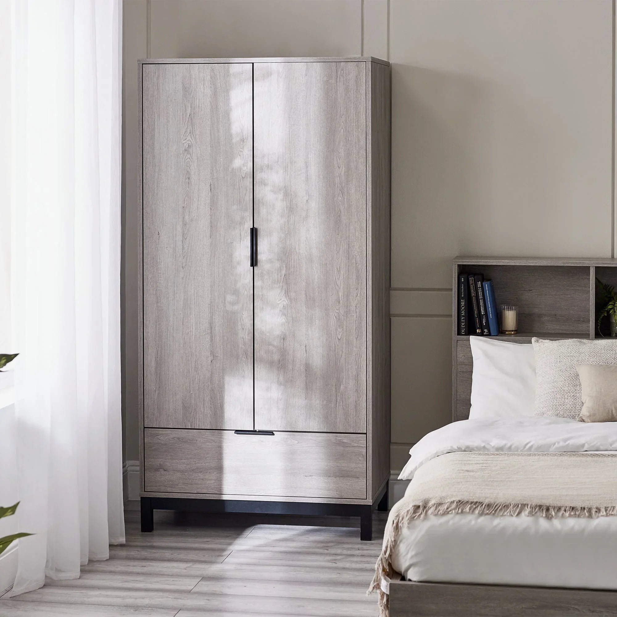 Light wood 2 door 1 drawer wardrobe in modern bedroom with matching bed and shelving