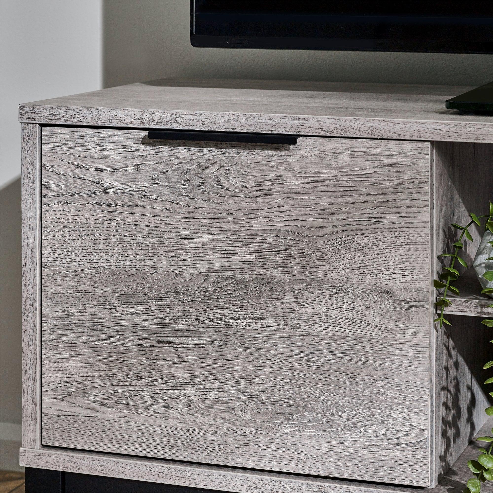 Grey oak TV unit cabinet door with black handle and wood grain texture