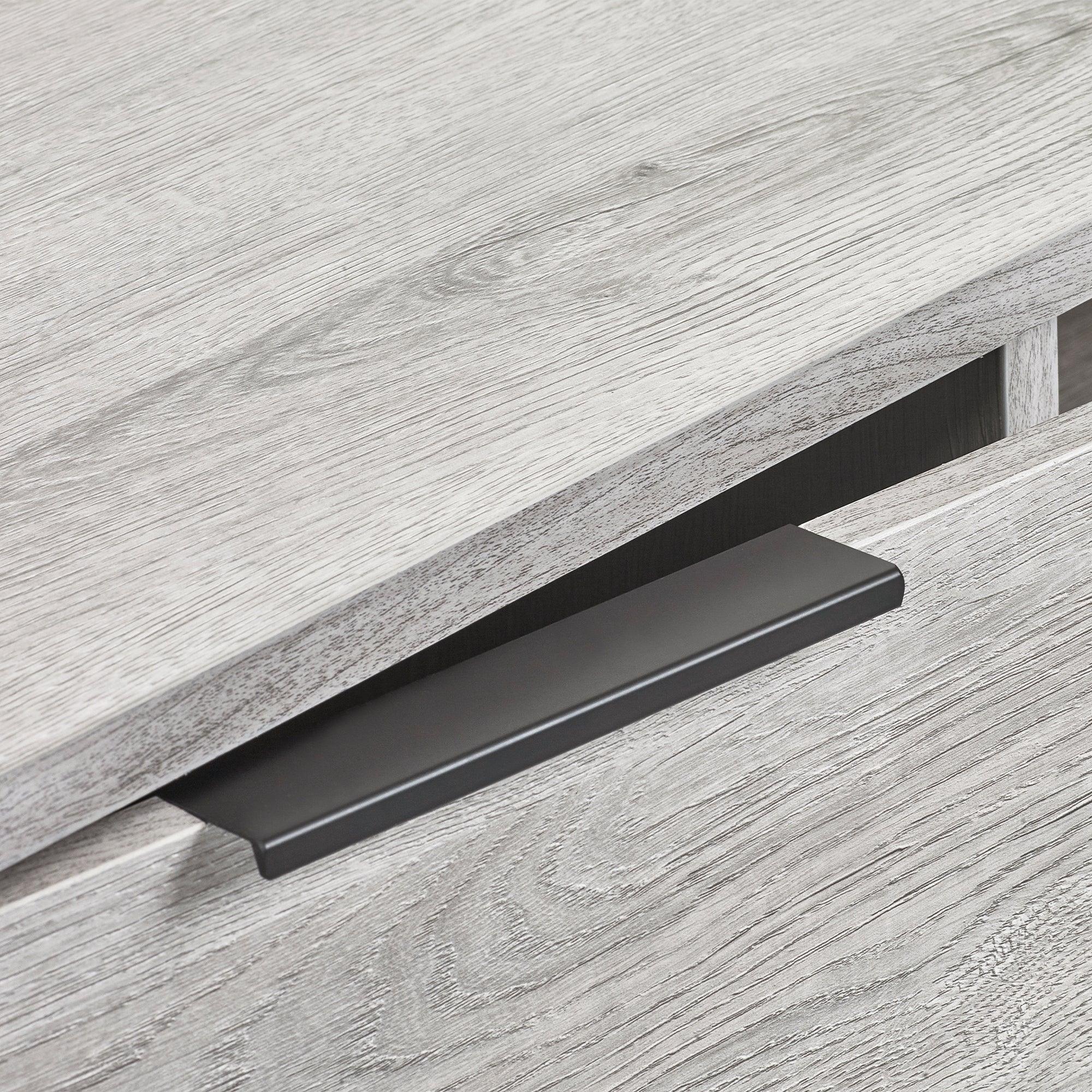 Grey oak TV unit drawer detail with black metal handle closeup