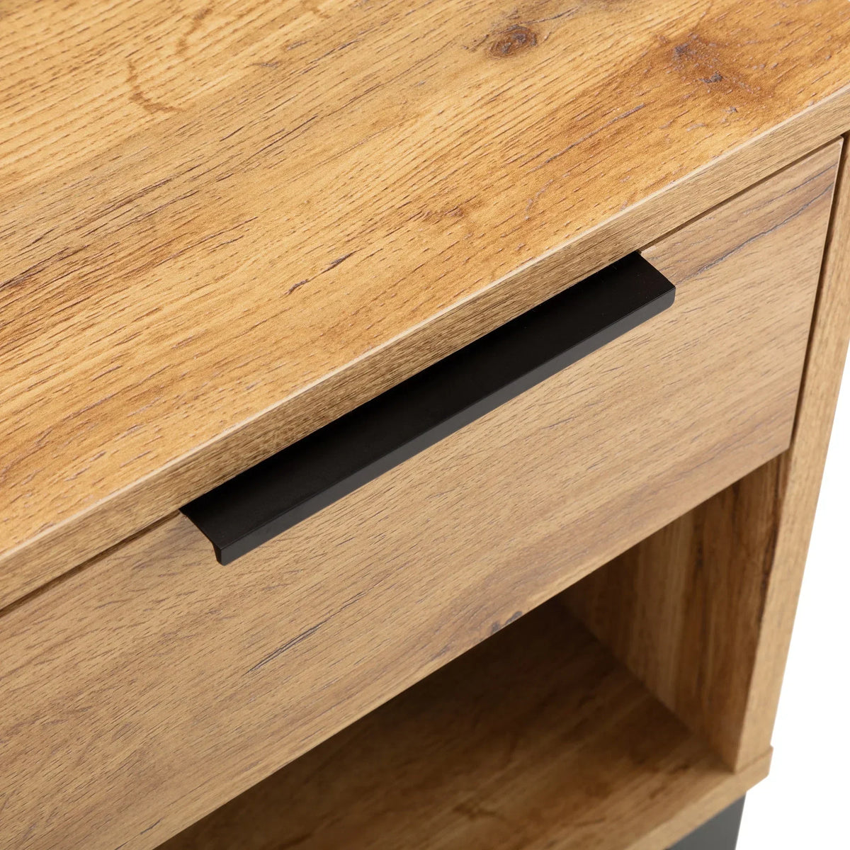 Oak bedside table with black metal drawer handle and open lower shelf, close-up view