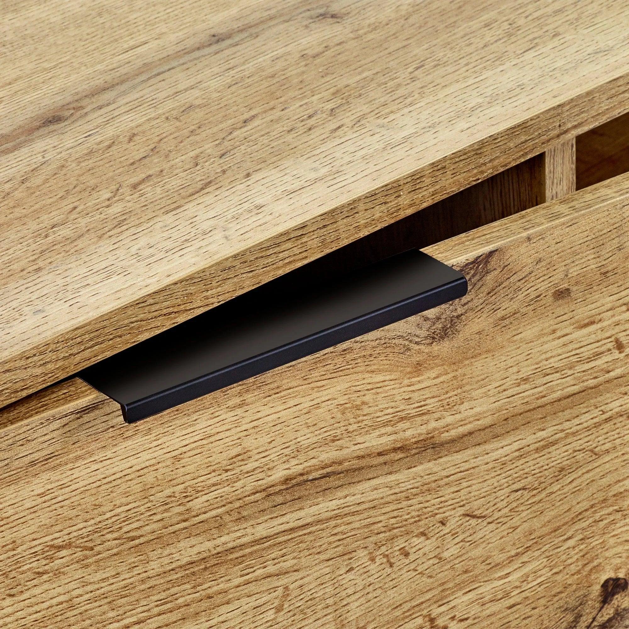Close-up of Bali TV unit light oak finish showing drawer front and black handle detail