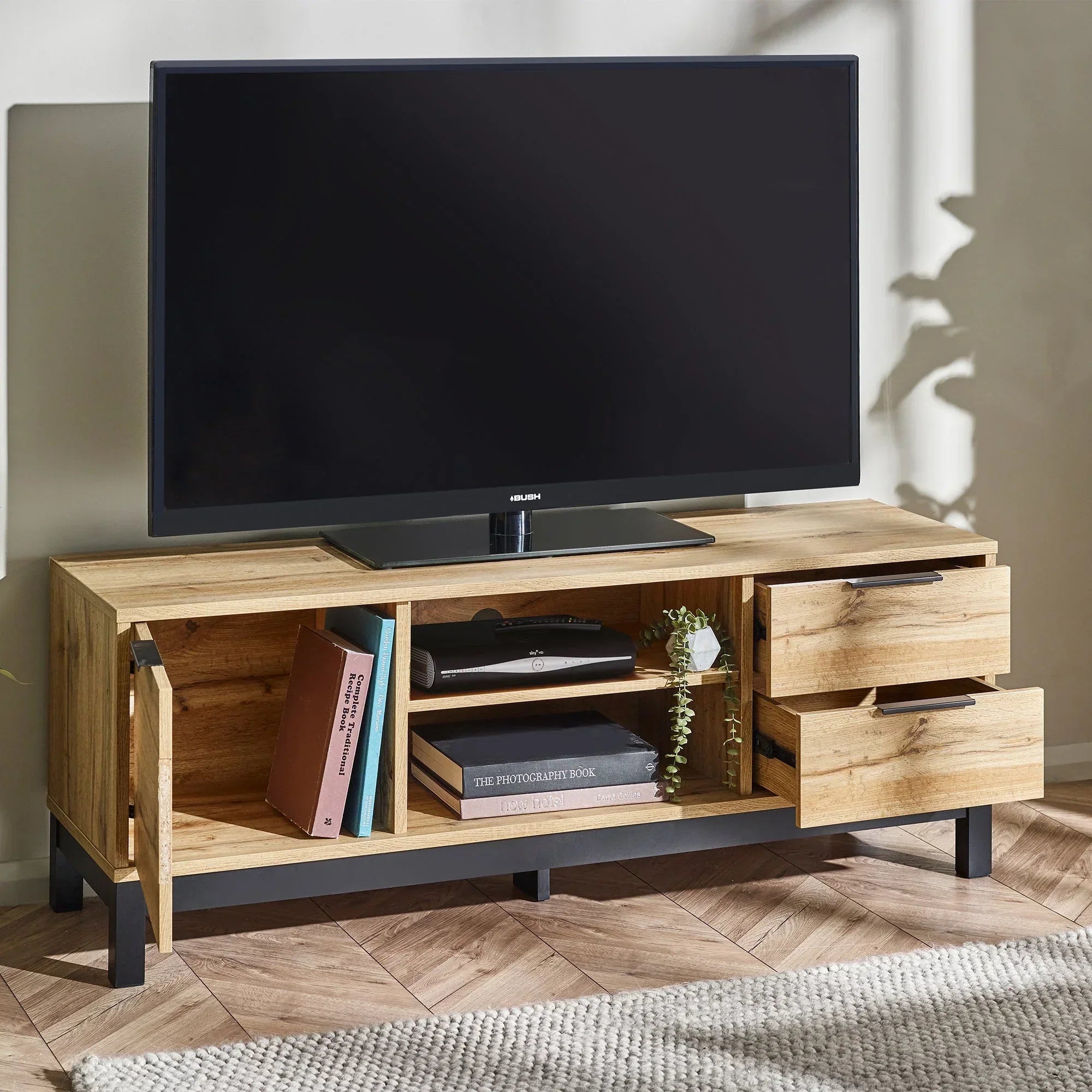 Light oak TV unit with shelves, two open drawers, books, and decor in modern living room