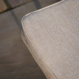 Close up of beige textured sofa cushion corner with neat piping detail
