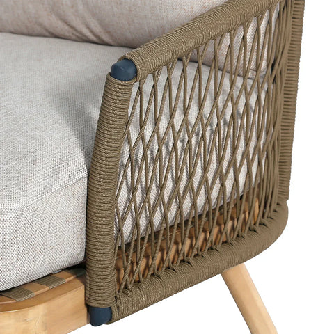 Close-up of beige rope armchair with woven armrest and light fabric cushion