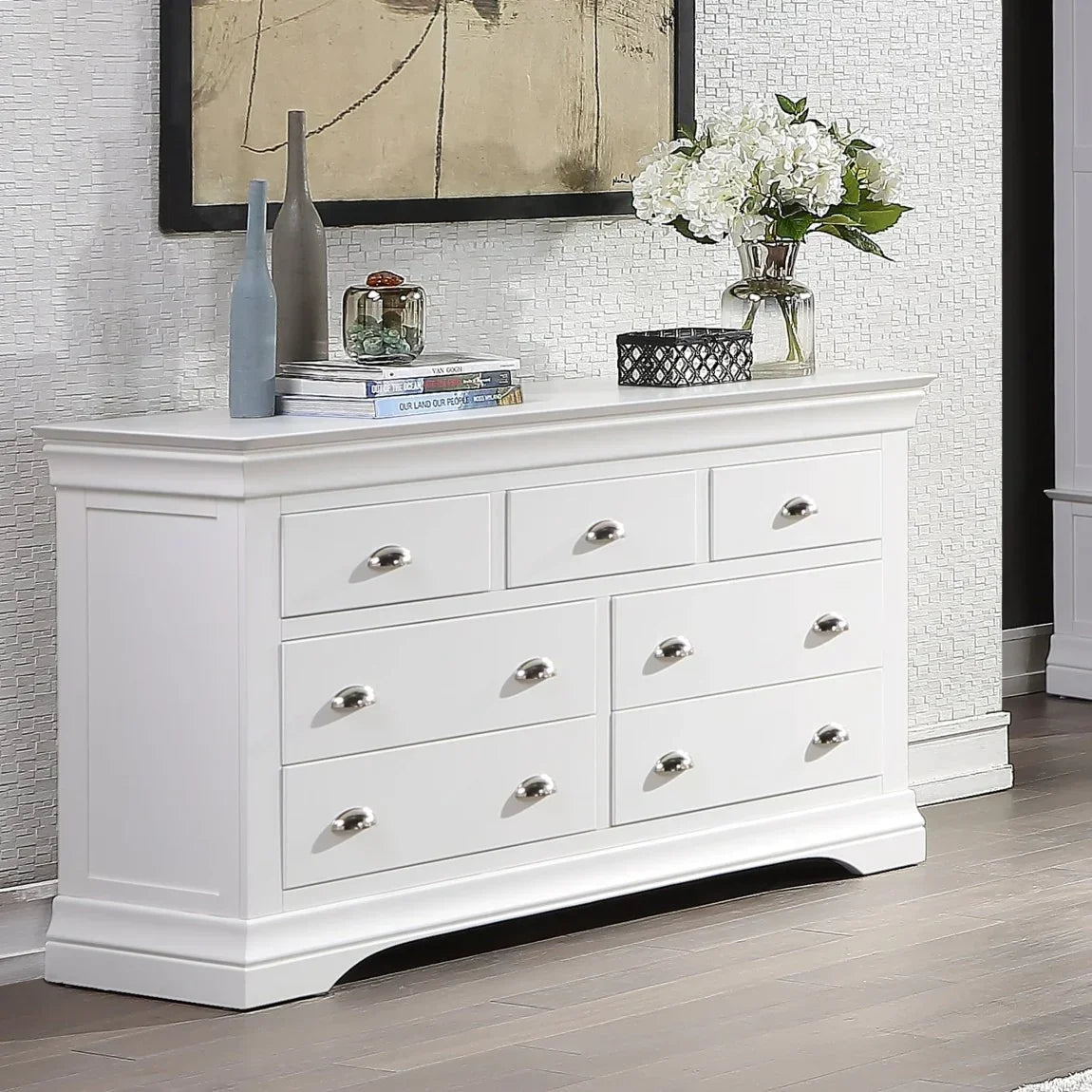 White chest of drawers with silver handles in modern living room setting