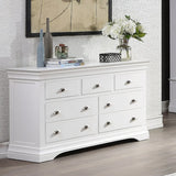 White chest of drawers with silver handles in modern living room setting