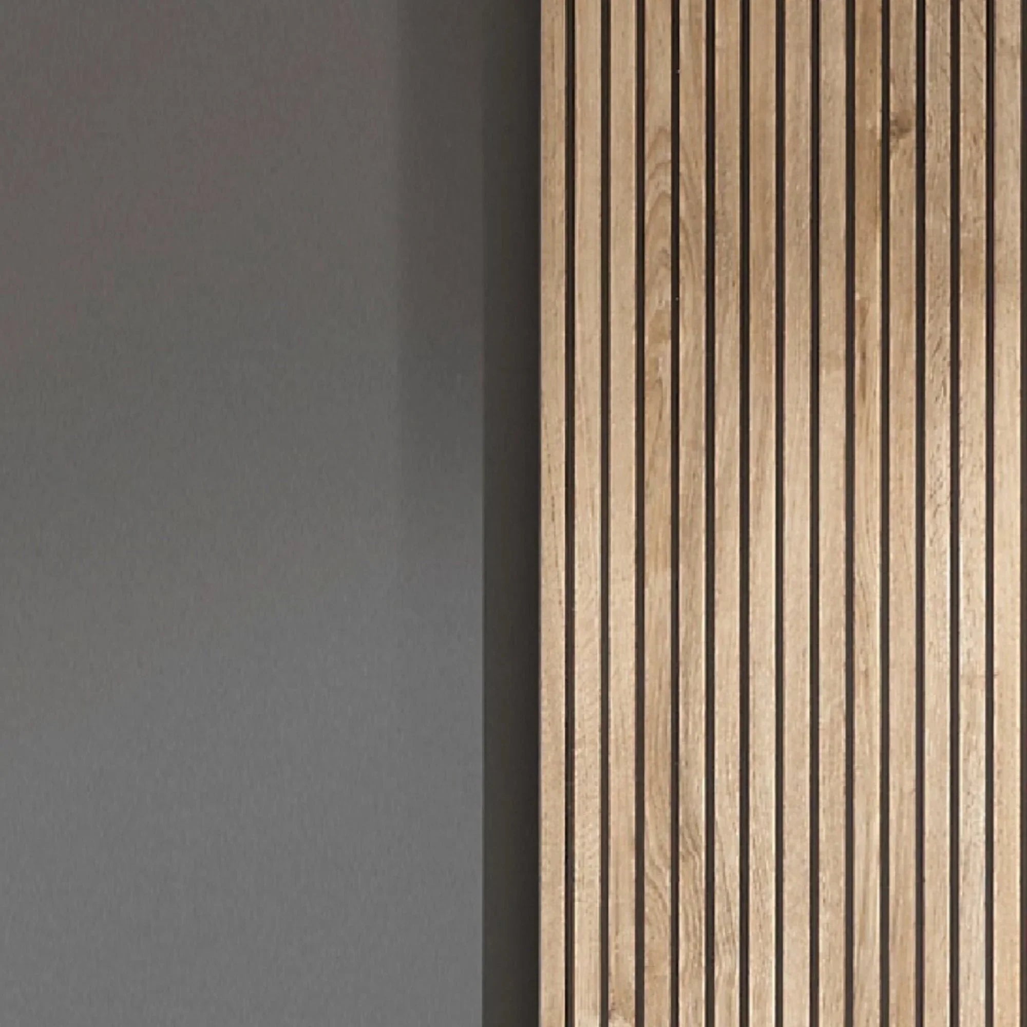 Oak wood slat wall panel beside smooth grey painted wall