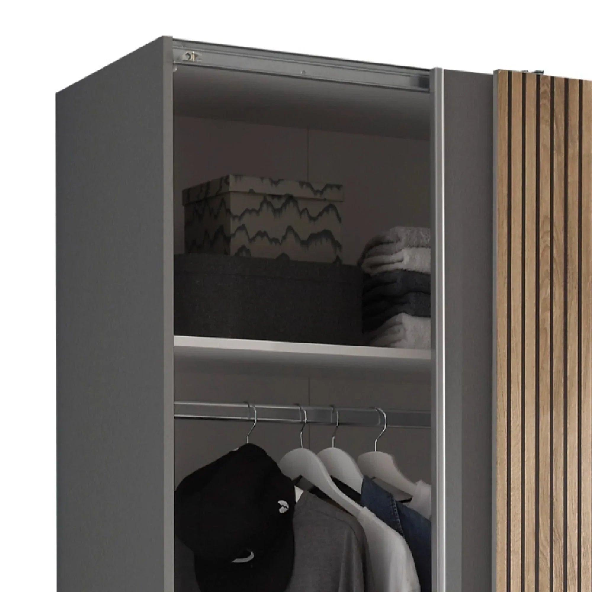 Grey wardrobe interior with hanging rail, folded towels, storage boxes, and wood panel detail