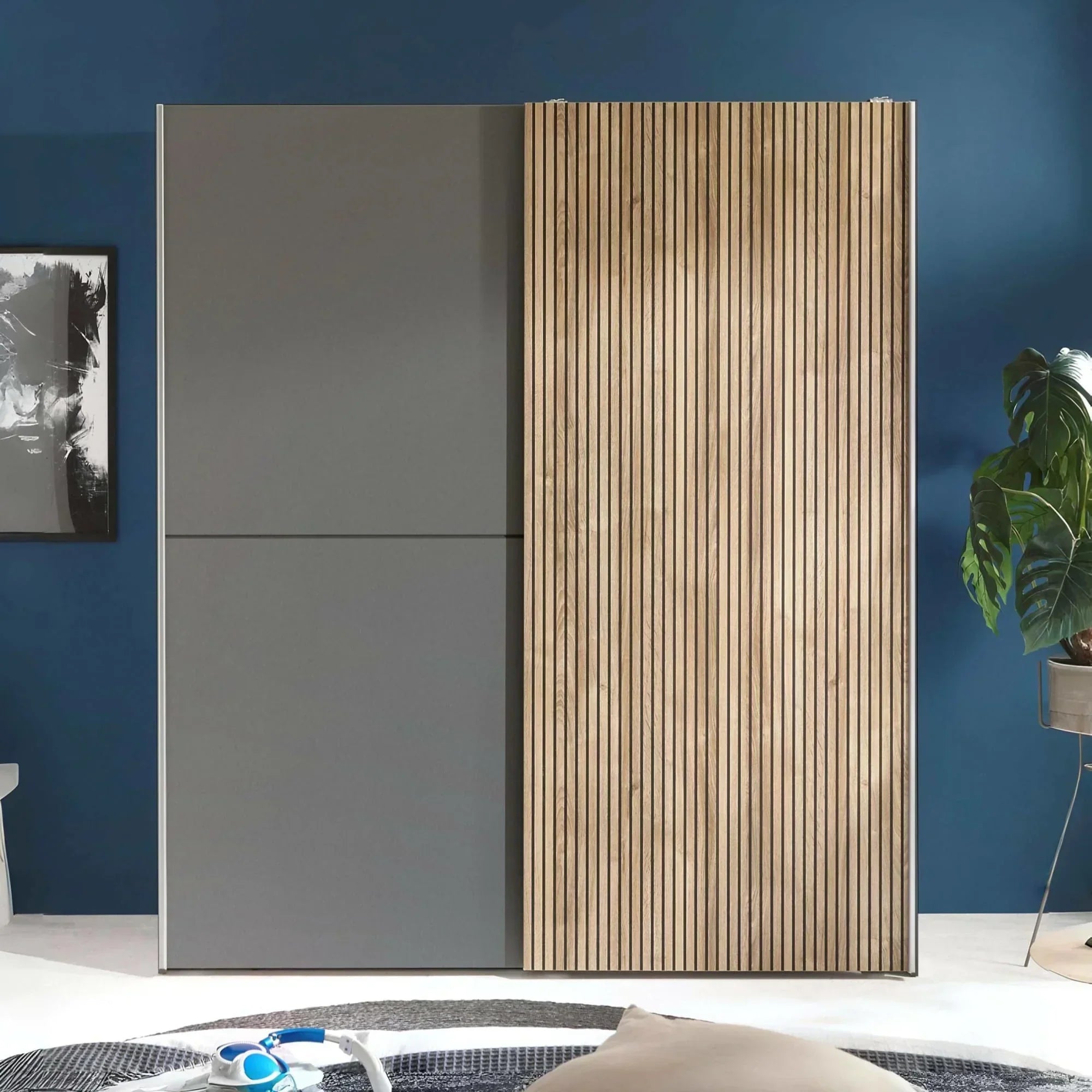 Modern wardrobe with grey panels and vertical wood slat sliding door against blue wall